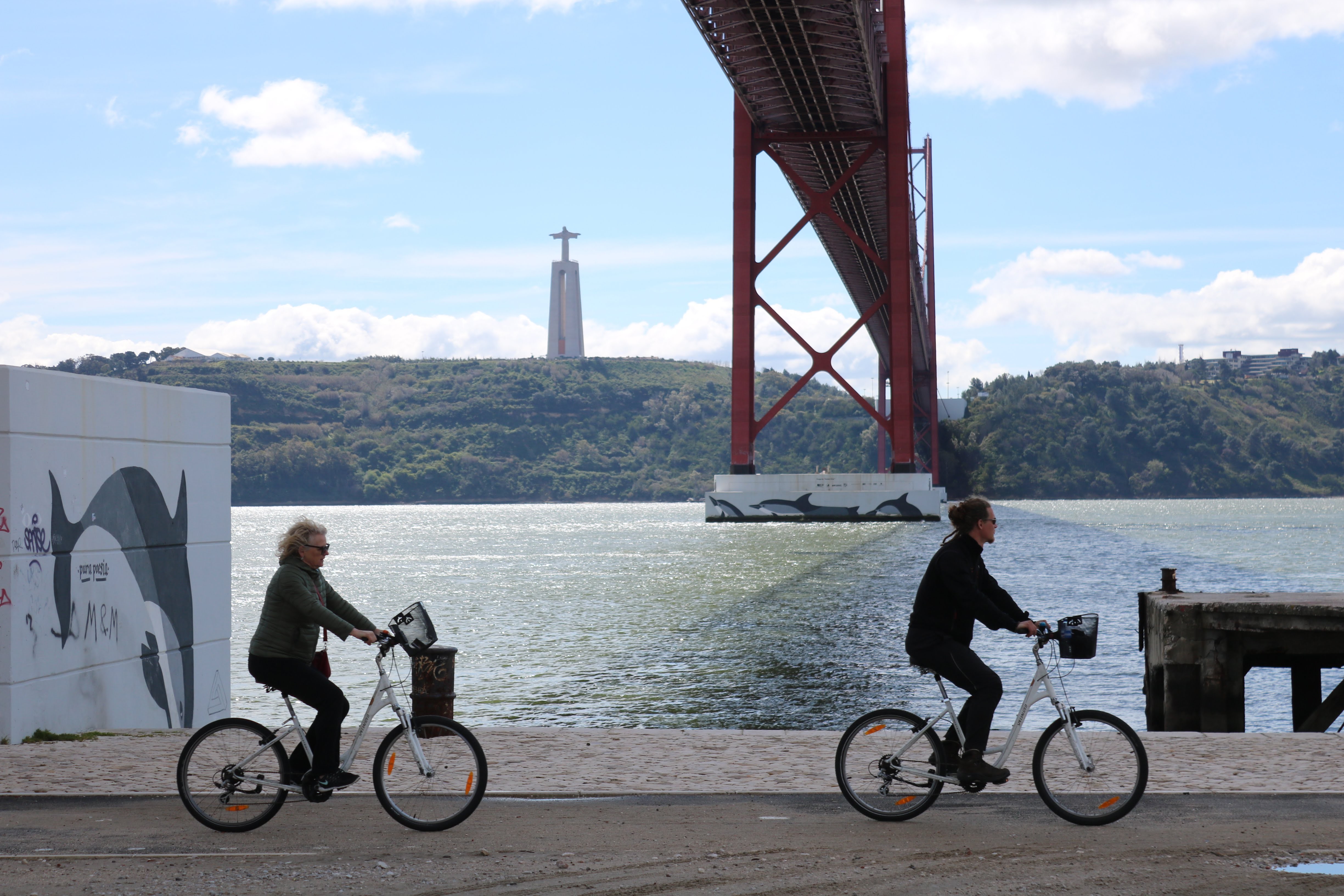 two people riding bicycles